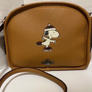 Coach X Peanuts lunch pail with Snoopy Ice skate motif.